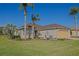Inviting single-story home surrounded by lush landscaping including mature palm trees at 13128 Se 97Th Terrace Rd, Summerfield, FL 34491