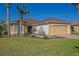 Charming single-story home with a manicured lawn, complemented by palm trees and a cozy two-car garage at 13128 Se 97Th Terrace Rd, Summerfield, FL 34491