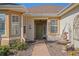 Close up view of a home's inviting front entrance with an olive green door at 13128 Se 97Th Terrace Rd, Summerfield, FL 34491