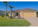 Charming single-story home featuring a manicured lawn and a two-car garage at 13128 Se 97Th Terrace Rd, Summerfield, FL 34491