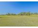 Beautiful golf course with manicured greens, sandy bunkers, and mature trees, providing a scenic backdrop at 13128 Se 97Th Terrace Rd, Summerfield, FL 34491