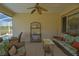 Comfortable covered lanai includes casual seating and view to the screened pool at 13128 Se 97Th Terrace Rd, Summerfield, FL 34491