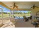 Covered lanai features outdoor dining, ceiling fans, and gorgeous golf course views at 13128 Se 97Th Terrace Rd, Summerfield, FL 34491