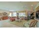 Spacious living room featuring tile floors, comfortable furniture, and a beautiful grand piano at 13128 Se 97Th Terrace Rd, Summerfield, FL 34491