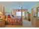 Comfortable main bedroom with a four-poster bed, complemented by soft carpeting and neutral walls at 13128 Se 97Th Terrace Rd, Summerfield, FL 34491