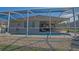 View of the screened-in pool and covered patio with ceiling fans, perfect for outdoor relaxation at 13128 Se 97Th Terrace Rd, Summerfield, FL 34491