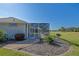Backyard view showcases a screened-in pool and golf course beyond at 13128 Se 97Th Terrace Rd, Summerfield, FL 34491