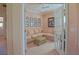 Bright sitting room featuring a comfortable sectional sofa, neutral carpet, and charming french doors at 13128 Se 97Th Terrace Rd, Summerfield, FL 34491