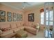 Bright room showcasing a comfortable L-shaped sofa, neutral carpet, and sunny window at 13128 Se 97Th Terrace Rd, Summerfield, FL 34491