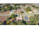 Aerial view shows a residential neighborhood with tree coverage, houses with driveways, and manicured lawns at 14059 Sw 47Th Ave, Ocala, FL 34473