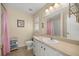 A well-lit bathroom features tile floors, a single sink vanity, and a shower with pink curtain at 14059 Sw 47Th Ave, Ocala, FL 34473