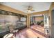 Charming screened patio with comfortable seating and a fan, perfect for relaxing outdoors at 14059 Sw 47Th Ave, Ocala, FL 34473