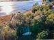 A stunning view of this waterfront property featuring mature landscaping and peaceful access to open water at 14540 Ne 250Th Ave, Fort Mc Coy, FL 32134