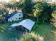 A high angle view reveals this charming countryside house, surrounded by mature landscaping and a storage shed at 14540 Ne 250Th Ave, Fort Mc Coy, FL 32134