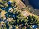 Aerial view of the home showcasing its tranquil lakefront setting, lush trees and its spacious lot at 14540 Ne 250Th Ave, Fort Mc Coy, FL 32134