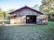 Exterior shot of a rustic barn with open doors, showcasing its potential for various uses at 14540 Ne 250Th Ave, Fort Mc Coy, FL 32134