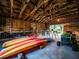 Spacious barn interior featuring ample storage, kayaks, and a riding lawnmower at 14540 Ne 250Th Ave, Fort Mc Coy, FL 32134