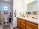 Clean bathroom featuring a vanity with sink, shower with curtain, and a toilet at 14540 Ne 250Th Ave, Fort Mc Coy, FL 32134