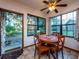 Cozy dining area with natural light featuring a round table, wooden chairs, and views of the wooded surroundings at 14540 Ne 250Th Ave, Fort Mc Coy, FL 32134
