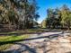 Driveway with lush greenery, trees, and a sense of secluded living at 14540 Ne 250Th Ave, Fort Mc Coy, FL 32134