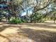 Beautiful stone facade house, with a well-maintained lawn, mature trees, and shrubs at 14540 Ne 250Th Ave, Fort Mc Coy, FL 32134
