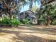 Attractive two-story stone home nestled among lush landscaping and mature trees at 14540 Ne 250Th Ave, Fort Mc Coy, FL 32134