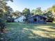 Charming home and rustic barn nestled in a lush green yard with stone accents and mature trees at 14540 Ne 250Th Ave, Fort Mc Coy, FL 32134