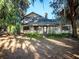 Lovely home with stone accents, a cozy porch with rocking chairs, and a well-manicured lawn at 14540 Ne 250Th Ave, Fort Mc Coy, FL 32134