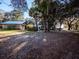 Picturesque property with a rustic barn, lush trees, and a charming house in the background at 14540 Ne 250Th Ave, Fort Mc Coy, FL 32134