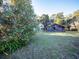Lush front yard featuring an orange tree, a charming house, and a rustic barn, creating a serene setting at 14540 Ne 250Th Ave, Fort Mc Coy, FL 32134