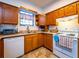 Efficient kitchen featuring oak cabinets, white appliances, and ample counter space for cooking and meal preparation at 14540 Ne 250Th Ave, Fort Mc Coy, FL 32134