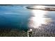 A vast lake scene with a wooden dock offers a serene view and private access to the calming waters at 14540 Ne 250Th Ave, Fort Mc Coy, FL 32134