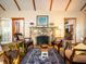 Living room showcasing a stone fireplace, hardwood floors, and stylish seating around a central rug at 14540 Ne 250Th Ave, Fort Mc Coy, FL 32134