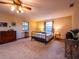 Large primary bedroom with neutral carpet, dresser, and windows for natural lighting at 14540 Ne 250Th Ave, Fort Mc Coy, FL 32134