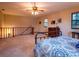 Large loft-style primary bedroom with neutral carpet, dresser, and staircase at 14540 Ne 250Th Ave, Fort Mc Coy, FL 32134