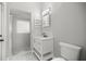 Bathroom boasts a modern vanity, decorative mirror, and tiled shower at 1628 Se 29Th Ter, Ocala, FL 34471