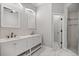 Stylish bathroom features double vanity, marble floors, and walk-in shower with neutral tile at 1628 Se 29Th Ter, Ocala, FL 34471