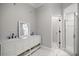 Bathroom with double vanity, marble floors, and tiled glass-enclosed shower at 1628 Se 29Th Ter, Ocala, FL 34471