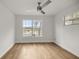 Bedroom with wood-look floors and a large window offering water views at 1628 Se 29Th Ter, Ocala, FL 34471