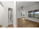 Open bedroom space with wood-look floors, bay window, and view to the ensuite bathroom at 1628 Se 29Th Ter, Ocala, FL 34471
