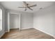 Neutral bedroom showcases wood floors, modern ceiling fan, and closet at 1628 Se 29Th Ter, Ocala, FL 34471