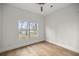 Bright bedroom with wood floors and a window overlooking a yard at 1628 Se 29Th Ter, Ocala, FL 34471