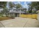 Beautiful two-story home with gray siding, large driveway, and mature trees at 1628 Se 29Th Ter, Ocala, FL 34471