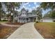 View of charming two-story home, long driveway, with detached garage in backyard at 1628 Se 29Th Ter, Ocala, FL 34471