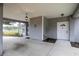 Covered entrance showing light gray siding, a lantern-style light fixture, and a white front door at 1628 Se 29Th Ter, Ocala, FL 34471
