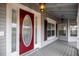 Lovely covered front porch with a decorative glass front door and traditional lighting fixture at 1628 Se 29Th Ter, Ocala, FL 34471