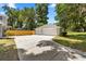 A three-car detached garage with a concrete driveway and ample parking space at 1628 Se 29Th Ter, Ocala, FL 34471