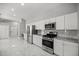 Modern kitchen featuring marble countertops, stainless steel appliances, and ample cabinet space at 1628 Se 29Th Ter, Ocala, FL 34471