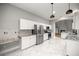 Open kitchen with stainless steel appliances, modern white cabinets, and stone countertops at 1628 Se 29Th Ter, Ocala, FL 34471