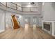 Bright living room featuring wood floors, fireplace, staircase, and open floor plan at 1628 Se 29Th Ter, Ocala, FL 34471